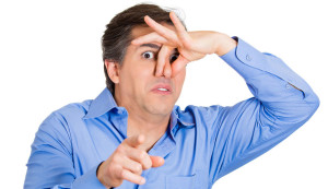 Closeup portrait, young man, disgust on face, pinches his nose, something stinks very bad smell, situation, pointing at you, isolated white background. Negative emotion facial expression feeling